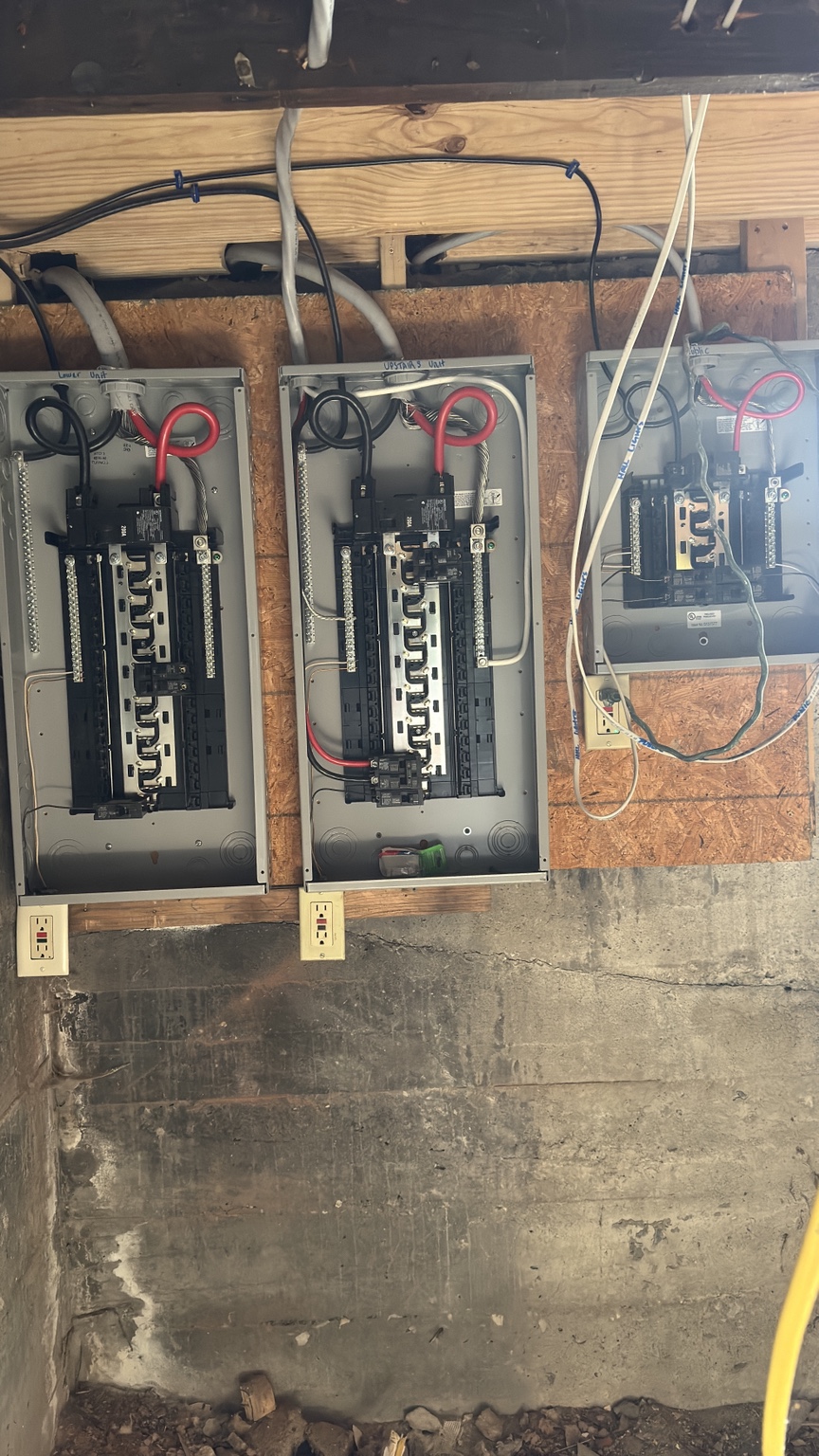 Three residential electrical panels during upgrade work